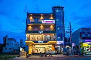 a building with motorcycles parked in front of it at Aadya Elite in Mysore