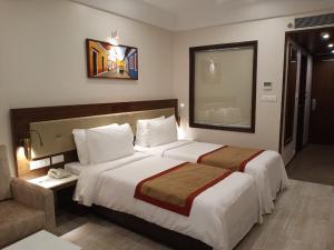 Letto o letti in una camera di Sobit Sarovar Portico
