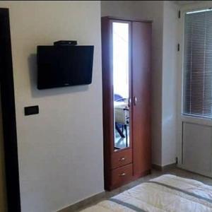 a room with a flat screen tv on a wall at Apartmani Luka in Herceg-Novi