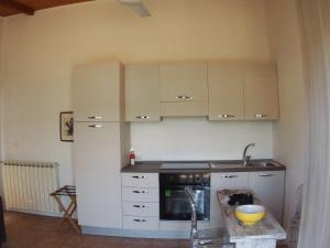 a kitchen with white cabinets and a stove top oven at Casa Vacanze Bungalow I Girasoli in Ventimiglia