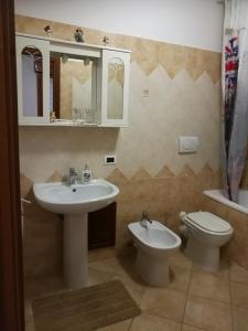 a bathroom with a sink and a toilet and a mirror at Camera Privata in Pomezia