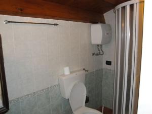 a bathroom with a white toilet in a room at Antico Baglio dei Pescatori in Carini