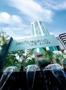 a sign in front of a building with a fountain at Pacific Regency Hotel Suites in Kuala Lumpur