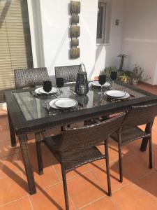 a black table with chairs and wine glasses on it at Condado de Alhama in Alhama de Murcia