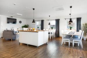 a kitchen and living room with a table and chairs at Brink Hotell in Eslöv