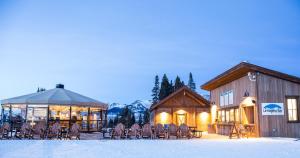 a building with chairs and a gazebo in the snow at View Of Mt, Crested Butte And Lifts 2 Br Condo Condo in Crested Butte