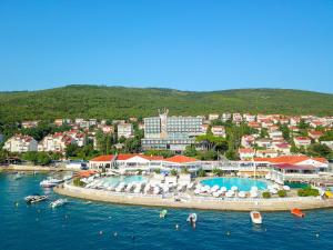 a resort with two swimming pools in the water at Hotel Katarina in Selce