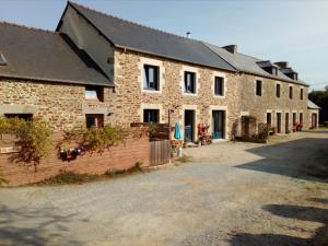 a large brick building with a driveway in front of it at La Lyonnais in Pleslin-Trigavou