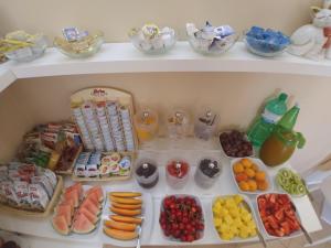 a refrigerator filled with lots of different types of food at Albergo Aurora in Malcesine