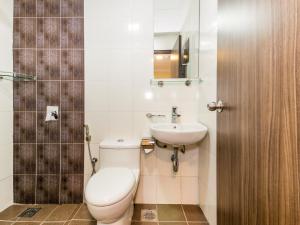 a bathroom with a toilet and a sink at OYO 431 Hotel De Grand Orchard in Kuala Lumpur