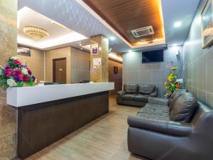 uma sala de espera com cadeiras de couro e um balcão de recepção em OYO 431 Hotel De Grand Orchard em Kuala Lumpur