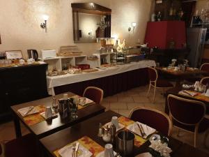 a restaurant with two tables and a counter with at Hotel Nassauer Hof in Wissen