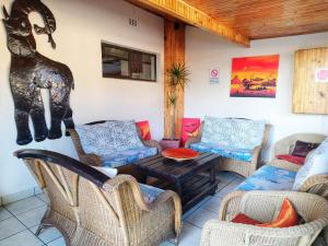 a living room with couches and a table and chairs at St Lucia Lodge in St Lucia