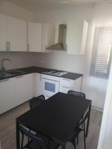 a kitchen with a black table and chairs in it at Casa vacanze Villa Algieri in Schiavonea +31 photos