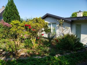 a garden in front of a house with flowers at Mini-apartment in the flowerbed in Søborg