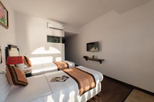 מיטה או מיטות בחדר ב-Bellevue Hotel