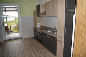 a kitchen with a sink and a counter top at Ferienwohnung Feldberger Seenlandschaft in Neuhof