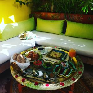 a tray of food on a table on a couch at Riad Laith in Marrakesh