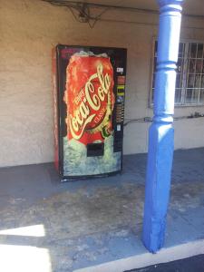 a drink vending machine sitting on the side of a building at Deluxe Inn Austin in Austin