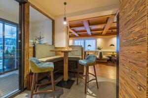 a dining room and living room with a table and chairs at Gasthof Tuscherhof in Braies