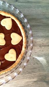 a chocolate pie with heart shaped cookies on a table at B&B I LAKE IT BELLAGIO in Bellagio