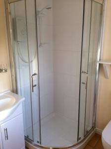 a shower with a glass enclosure in a bathroom at Dewhamill in Bellaghy