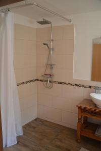 a bathroom with a shower and a sink at Im Maifeld in Kalt