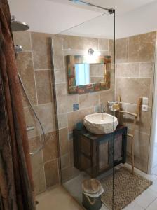 a bathroom with a shower with a sink and a mirror at Résidence Village Marin Catalan TORREILLES PLAGE in Torreilles
