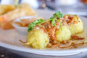 a plate of food with potatoes and beans on a table at Myanandar Residence & Hotel in Yangon