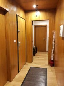 a hallway with wooden walls and a door and a rug at InPorto in Porto +5 photos