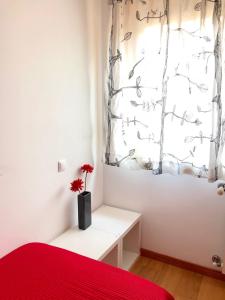 a bedroom with a red bed and a window at InPorto in Porto