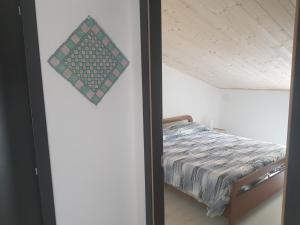 a bedroom with a bed and a glass door at La Casetta di Vitty in Conza di Campania