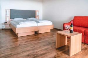 1 dormitorio con 1 cama y 1 mesa con copas de vino en Ferienhof Laurentius en Oedheim