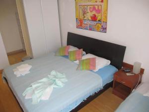 a bedroom with a bed with a bow on it at Apartments Almaja Villa in Petrovac na Moru