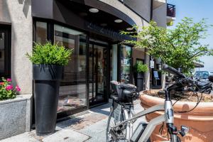 a bike parked in front of a store at Hotel Le Littoral in Évian-les-Bains
