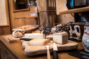 a table topped with cheese and bread on a counter at Hotel Le Littoral in Évian-les-Bains