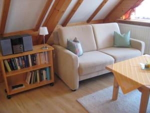 a living room with a couch and a book shelf at Haus Anja in Titisee-Neustadt