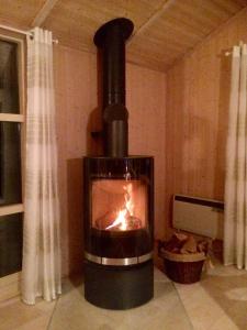 a fireplace in a room with a fire in it at Ferienhaus Strandmuschel in Schönhagen