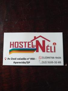 a ticket for a house with a sign on it at Hostel Néli in Aparecida