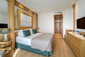 a hotel room with a bed and a flat screen tv at Las Arenas Balneario Resort in Valencia