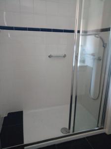 a bathroom with a shower with a glass door at Casas do Eido e Casa da Viúva in Celorico de Basto