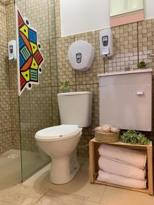 a bathroom with a toilet and towels in it at Mandala House Container in Chapada dos Guimarães +28 photos