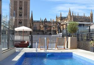 
a large swimming pool in front of a large building at EME Catedral Hotel in Seville
