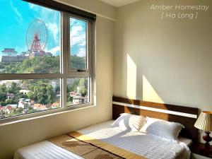a bedroom with a bed and a large window at Amber Homestay Hạ Long in Ha Long +24 photos