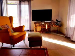 Linardići的住宿－Casa MiA，客厅配有电视、沙发和椅子