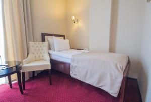 A bed or beds in a room at Marionn Hotel