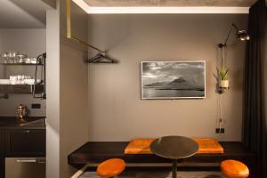 a dining room with a table and some orange chairs at R13 - A Townhouse Hotel in Reykjavík