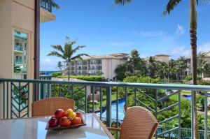 a bowl of fruit on a table on the balcony of a resort at Waipouli Beach Resort Gorgeous Luxury Ocean View Condo! Sleeps 8! in Kapaa