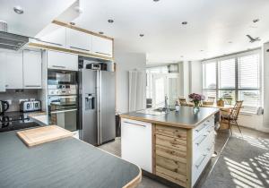 a kitchen with white cabinets and a counter top at Ark at Anchor in Edinburgh