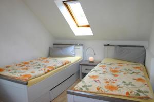 a bedroom with two beds and a skylight at Alter Bahnhof in Ennepetal